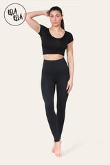 Model wearing black high waisted sculpt leggings with tummy control
