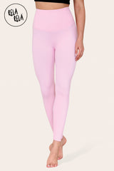 Front view of baby pink high waisted leggings on model standing upright, showing tummy control effect
