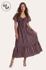 Front view of a model wearing the Chocolate Stripe Smocked Maxi Dress, highlighting the rich espresso vertical stripes and the adjustable lace-up neckline.