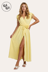 Front view of a model in the Yellow Flower Corsage Wrap Maxi Dress, demonstrating the adaptive UK 6-16 fit and the vibrant sunshine-hued drape.