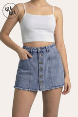 Front view of a model wearing the Rela Rela Blue multi-button stretchy denim skorts. Highlights the structured button-down detail and the flattering mid-rise sculpting fit.