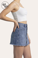 Side profile of the Blue denim skorts, showing the mini-length silhouette and the seamless integration of the under-shorts for a secure fit.