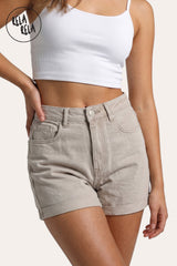 Front view of a model wearing Rela Rela's Beige sculpting high-waisted denim shorts. Highlights the tummy-control waistband, signature multi-button-style feel, and the permanent turn-up cuff.