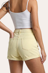Back view of a model wearing Rela Rela's Lemon high-waisted denim shorts, showing the back pockets, sculpting fit, and cuffed hem.