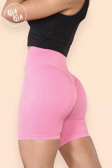 Side angle of pink high waisted cycling gym shorts with snug fit