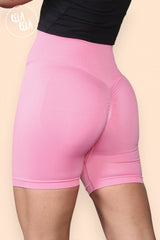 Back view showcasing ruched scrunch bum design on pink gym shorts