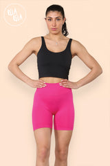 Model wearing high waisted hot pink scrunch bum shorts