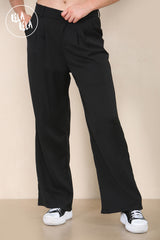 Close-up of waistband and tailoring details on black wide leg trousers