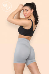 Side angle of grey high waisted cycling gym shorts with snug fit