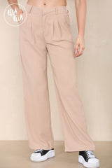 Close-up of waistband and tailoring details on camel wide leg trousers