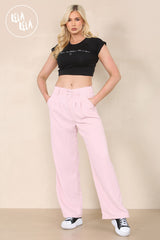 Front view of high waisted wide leg tailored trousers in rose pink for women