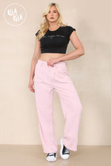 Model wearing rose pink going out trousers with heels – full outfit look