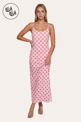 Front view of a model wearing the Pink Retro Polka Dot Slit Maxi Slip Dress, highlighting the soft rosy hue and the elegant scoop neckline.