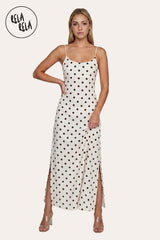 Front view of a model in the White Retro Polka Dot Slit Maxi Slip Dress, highlighting the elegant scoop neck and the double side slit detail in a summer-ready outfit.