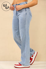 Side profile of woman in rhinestone embellished light blue jeans, mid-stride for a dynamic, casual look.