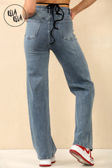 Back view of denim blue wide leg jeans showing mid-rise fit and pocket design.