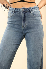 Close-up of rhinestone embellishments on denim blue viral mid-waisted stretchy jeans.