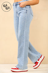 Side view of women's light blue stretchy jeans with scattered rhinestones and wide leg fit.
