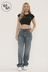 Model wearing denim blue sparkle jeans with mid-waist cut and rhinestone scatter.