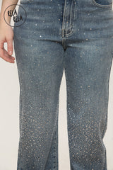 Detail shot of viral stretch sparkle jeans in denim blue with subtle rhinestone accents.