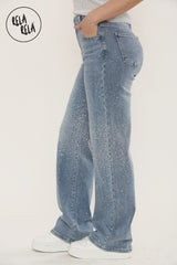 Side view of women's mid blue viral stretch sparkle denim jeans with mid-waist fit.