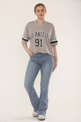 Model wearing high waist flare jeans in vintage blue, front angle