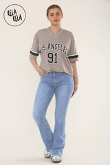 Front view of women's flared stretchy jeans in mid blue, high waist pull-on style pair with a tee shirt