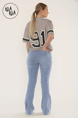 Back view of stretchy flare jeans women – mid blue with flattering flare cut