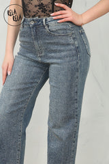 Detailed view of pull-on waistband on rhinestone jeans in denim blue