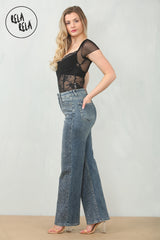 Side profile of mid waist rhinestone jeans in denim blue, wide leg fit