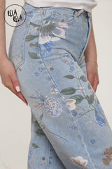 Close-up of blue floral print jeans showing wide leg, comfort fit, and flower on jeans
