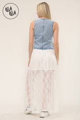 Back view of woman wearing elegant white lace maxi skirt with sheer texture
