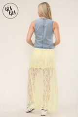 Back view of woman wearing elegant yellow lace maxi skirt with sheer texture