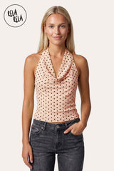 Front view of a model in the Blush Pink Polka Dot Mesh Halter Top, highlighting the dreamy cowl neck and the soft rosy hue.