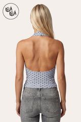Rear view of the model wearing the Baby Blue halter top, demonstrating the elegant backless design and the secure tie-neck fastening at the nape of the neck.