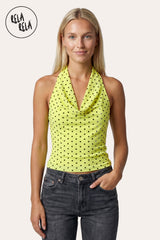 Front view of a model in Rela Rela’s Yellow Draped Polka Dot Mesh Halter Top, highlighting the radiant sunshine hue and the elegant cowl neck drape in a vibrant summer outfit.