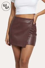 Front view of chocolate faux leather wrap front skorts with asymmetric design