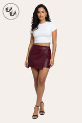 Model wear in styled outfit featuring burgundy asymmetric faux leather skorts for women