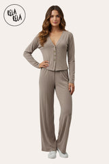 Front view of a model wearing RELA RELA’s Taupe V-neck button-up top and wide-leg trousers co-ord set. The earthy neutral tone and high-waisted silhouette create a streamlined, elegant two-piece look.
