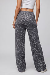 Back model view of grey sparkling sequin trousers with an elasticated waistband and wide-leg silhouette.