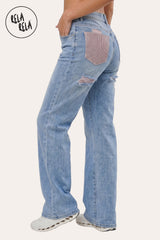 Side profile of the model in the Blue stretchy ripped jeans, demonstrating the high-recovery stretch fabric's contouring effect and the sleek, flattering silhouette.