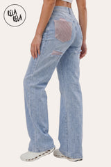 Side profile of the model in the Light Blue stretchy ripped jeans, demonstrating the high-recovery stretch fabric's contouring effect and the sleek silhouette.