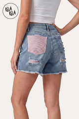 Rear view of the model wearing the Light Blue Shorts, demonstrating the statement pink rhinestone back pocket and the sculpting fit.