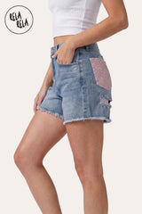 Side profile of the model in the Pink Rhinestone Denim Shorts, highlighting the high-waisted fit and the shimmering crystal pocket detail from the side.