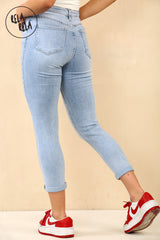 Light blue cropped skinny jeans womens rear view emphasizing mid rise and stretch.