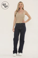 Model wearing high waisted stretchy wide leg jeans in rinse blue