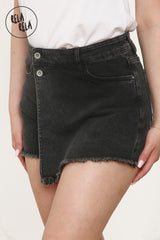 Close-up of the stretchy waistband, frayed hem and front buttons details on the asymmetric black wrap front skort