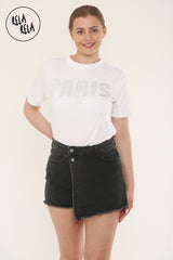 Model wearing a black mid-rise skort in asymmetric wrap front style