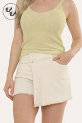 Front view of women's cream asymmetric denim skorts with mid-rise waist