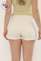 Back view showing the cream stretchy denim skort with back pockets